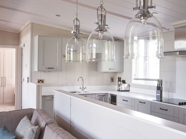 A kitchen with cabinets, sink, and appliances at Milk Wood 3 in Laugharne