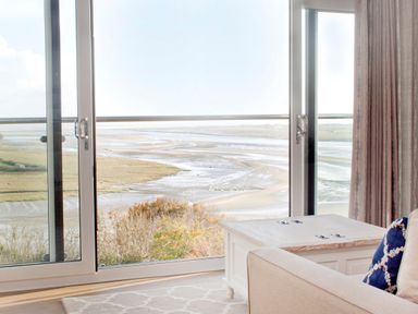 A living room with a view of the landscape at Milk Wood 3 in Laugharne