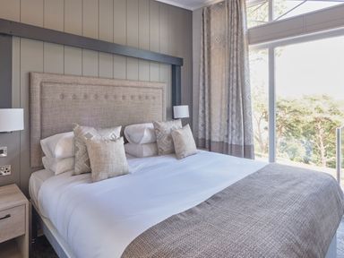 A bedroom with a bed and window at Milk Wood 3 Spa in Laugharne