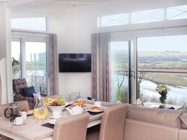 A dining area with a table set for breakfast at Milk Wood 3 Spa in Laugharne