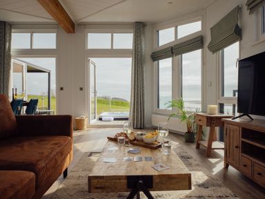 A living room with a sofa and coffee table at Apex Spa in Laugharne