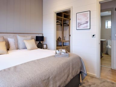 A bedroom with a bed, closet, and bathroom door at Epic Spa in Laugharne