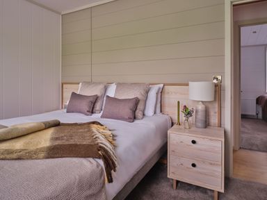 A bedroom with a bed and bedside table at Epic Spa (Pet) Laugharne