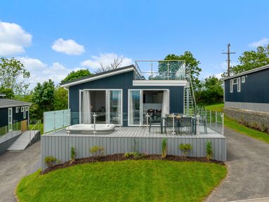 A house with a deck and hot tub at Sonnet 3 Roof Terrace Spa Laugharne