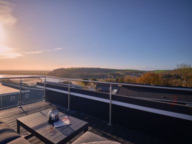 A rooftop terrace with a table and view at Sonnet 3 Roof Terrace Spa in Laugharne