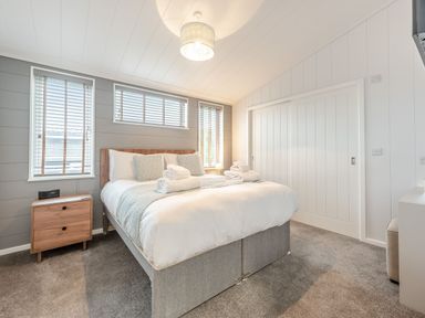 A bedroom with a bed and bedside table at Sonnet 3 Roof Terrace Spa in Laugharne