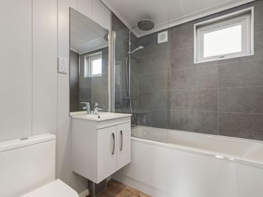 A bathroom with a bathtub and shower at Sonnet 3 in Laugharne