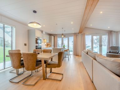 A living room with a dining area and kitchen at Epic Spa (Roof Terrace) (Pet) in Laugharne