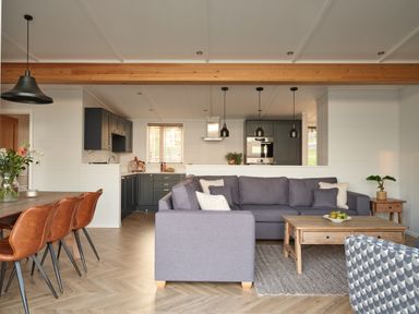 A living room with a sofa and dining area at Canto Spa (pet) in Laugharne