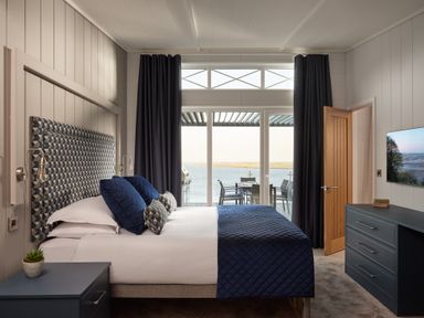 A bedroom with a bed and a view at Canto Spa (pet) Laugharne