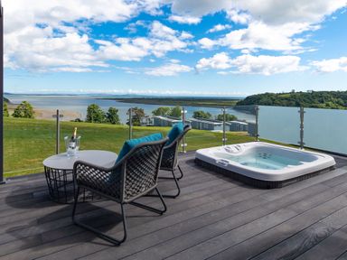 An outdoor terrace with seating and a hot tub at Apex Spa (Pet) Laugharne