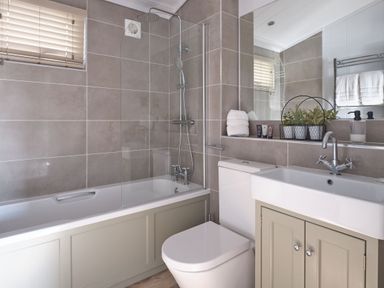 A bathroom with a shower and bathtub at Apex Spa (Pet) Laugharne