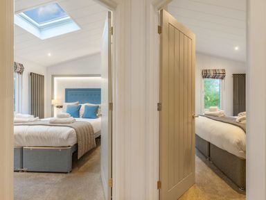 A bedroom with two beds and a skylight at Apex Spa (Pet) in Laugharne