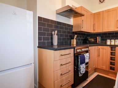 A kitchen with refrigerator and oven at Chapel Cottage Mevagissey