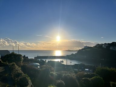 A view of the ocean with boats at Chapel Cottage Mevagissey