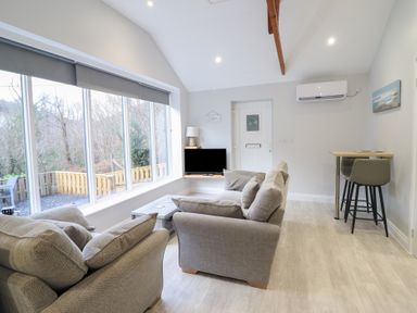 A living room with a sofa and television at Lodge at Nadur