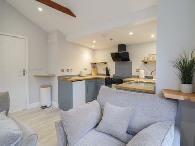 A kitchen with a sofa and various appliances at Lodge at Nadur