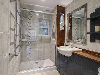A bathroom with a shower and sink at Lodge at Nadur 