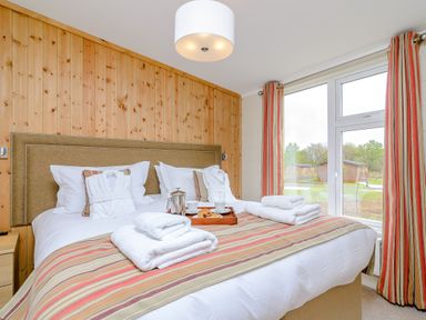 A bedroom with a bed and side table at The Fotheringhay in Kings Cliffe