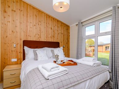 A bedroom with a bed and side table at The Folkesworth in Kings Cliffe