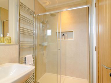 A bathroom with a shower and sink at The Fotheringhay (Pet) in Kings Cliffe