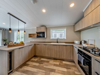 A kitchen with cabinets and appliances at Saron 2.0 Pet in Llandyrnog