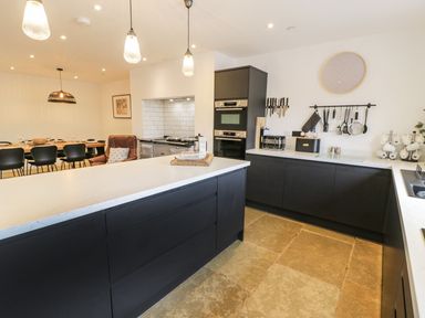 A kitchen with an island and appliances at Cae Sam in Pentraeth