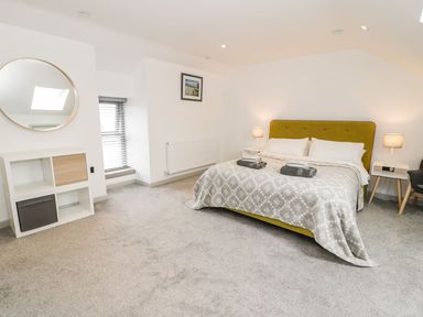 A bedroom with a double bed and decorative items at Cae Sam in Pentraeth