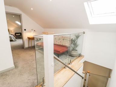A staircase with a plant and seating area at Cae Sam in Pentraeth