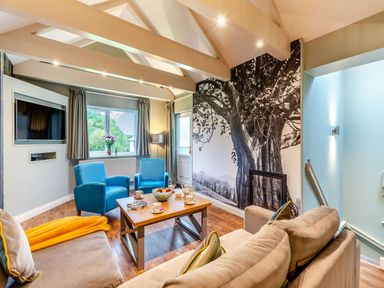 A living room with a tv and coffee table at The Whitbarrow Den Penrith