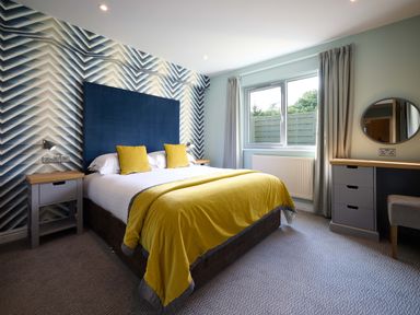 A bedroom with a bed and nightstand at The Whitbarrow Den in Penrith