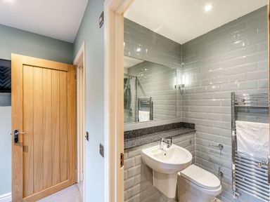 A bathroom with a sink and toilet at The Whitbarrow Den in Penrith