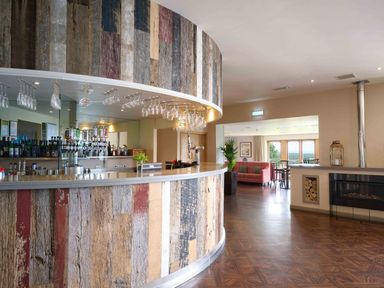 A bar with a counter and seating area at Fell Side in Penrith