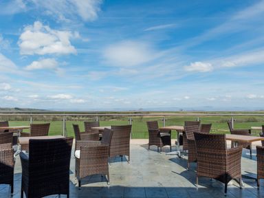An outdoor seating area with tables and chairs at Fell Side in Penrith