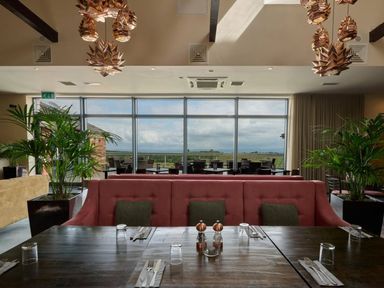 A restaurant with seating and large windows at Fell Side in Penrith