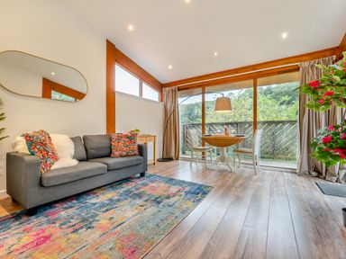 A living room with a sofa and a table at Piran Spa Lodge Pet in Perranporth