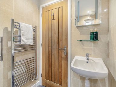 A bathroom with a towel rail and sink at Droskyn Spa Pet Perranporth