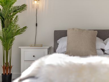 A bedroom with a bed and nightstand at The Farmhouse (Pet) Perranporth