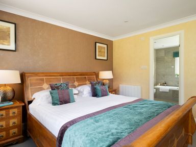 A bedroom with a bed and bedside tables at The Allensford (Pet) Slaley