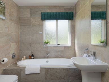 A bathroom with a bathtub and sink at The Allensford (Pet) in Slaley