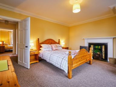 A bedroom with a bed and a nightstand at West Lodge in Kirriemuir