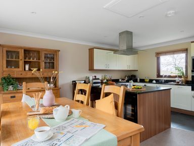 A kitchen with dining table and chairs at The Derwent in Slaley