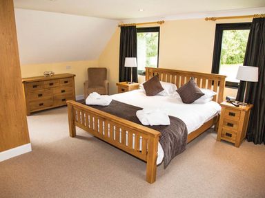 A bedroom with a bed and dresser at The Derwent in Slaley