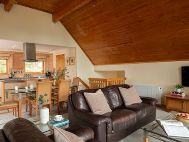 A living room with a sofa and dining area at The Hexham in Slaley