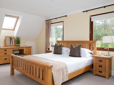 A bedroom with a bed and nightstands with lamps at The Hexham in Slaley