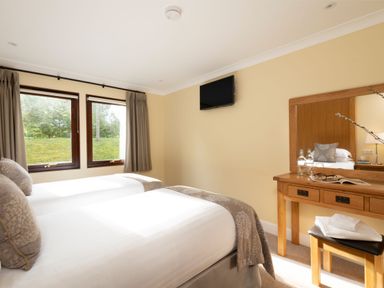 A bedroom with two beds and a TV at The Hexham (Pet) in Slaley