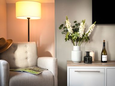 A living room with an armchair and a side table at The Hexham Spa in Slaley