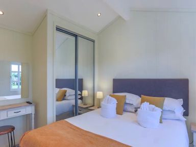 A bedroom with a bed and mirror at Stokesley (Pet) Great Ayton
