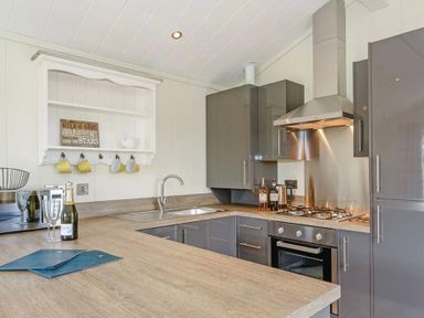 A kitchen with a counter, sink, and oven at Stokesley (Pet) in Great Ayton