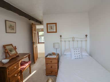 A bedroom with a bed and a desk at Long Linney in Bideford